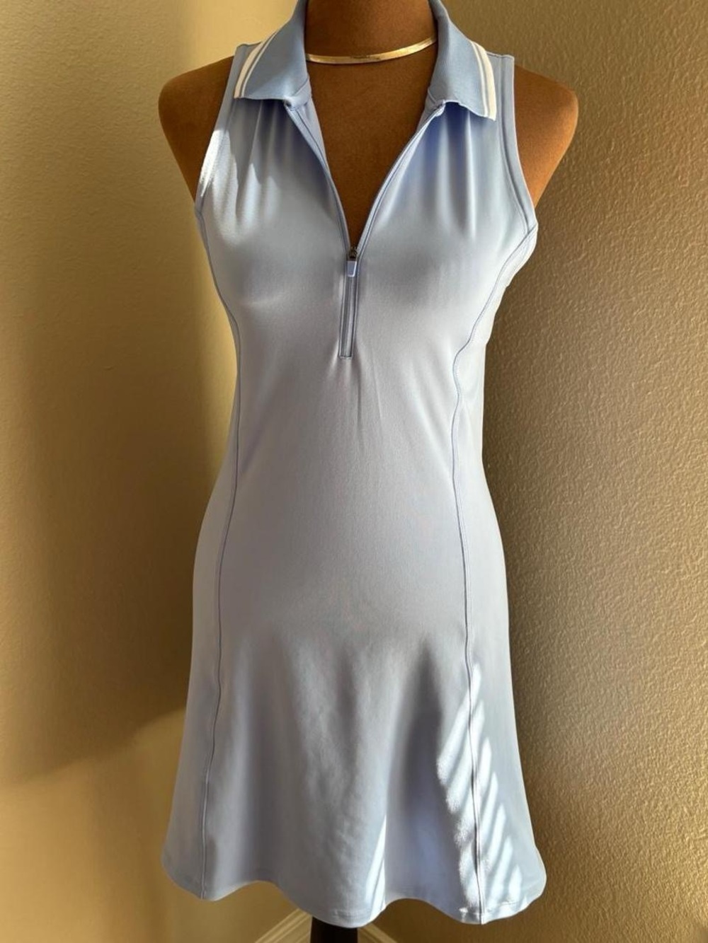 Baby blue tennis dress with white collar trim and zipper in the front and the ba